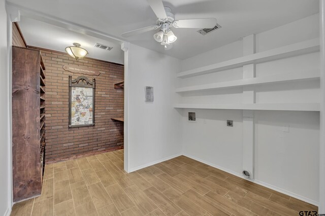 2010 County Road 4250, Winnsboro, TX 75494 - laundry room featuring brick wall, electric dryer hookup, washer hookup, ceiling fan, and light wood finished floors