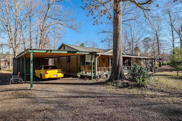 view of front facade featuring a porch and a carport