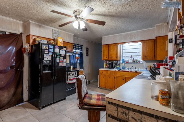 kitchen featuring a textured ceiling, light tile patterned floors, sink, ceiling fan, and black fridge with ice dispenser