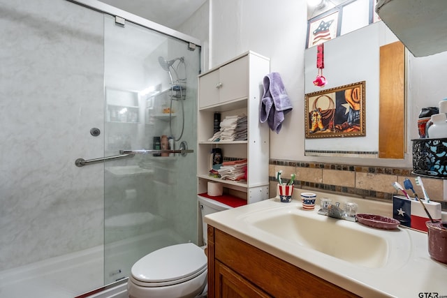 bathroom with toilet, vanity, and walk in shower