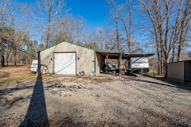 view of outdoor structure featuring a garage and a carport