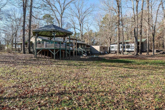 view of yard with a deck and a gazebo