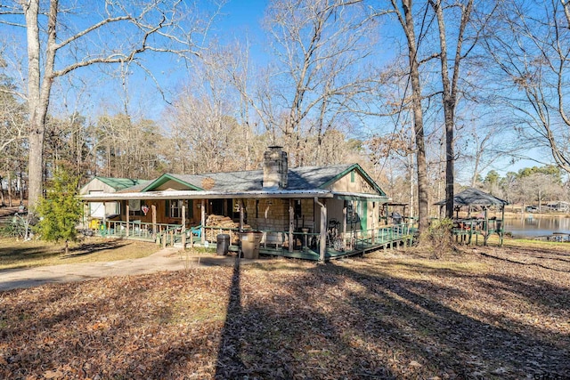 back of house featuring a water view and a gazebo