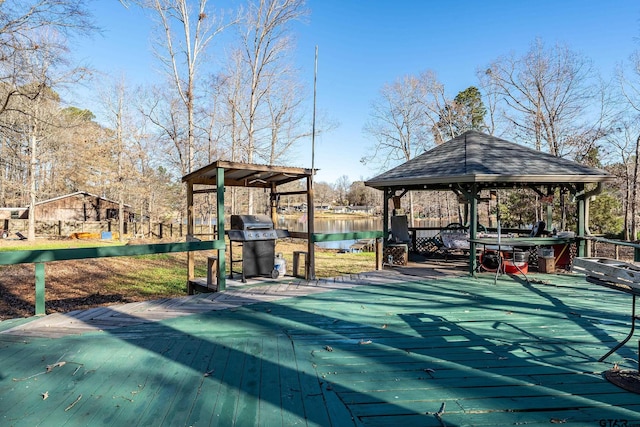 exterior space featuring a deck with water view, a gazebo, and grilling area