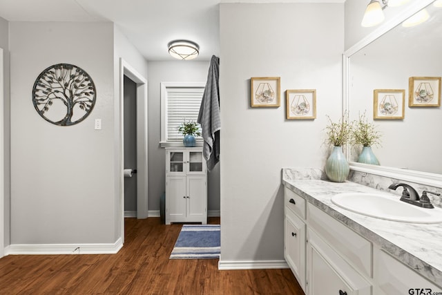 5513 Bostick Dr, Tyler, TX 75707 - bathroom with wood finished floors, vanity, and baseboards