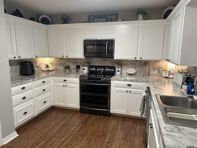 kitchen with range with two ovens, white cabinets, backsplash, and dark wood-type flooring