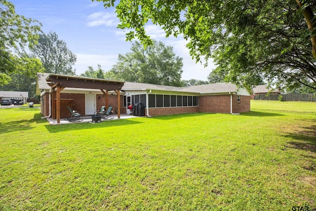 5513 Bostick Dr, Tyler, TX 75707 - back of property with a patio, brick siding, and a sunroom