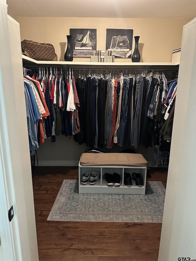 spacious closet with dark wood-style floors