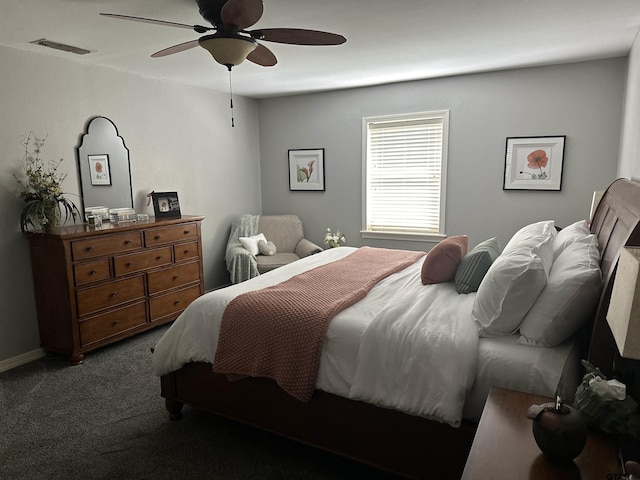 bedroom featuring dark colored carpet, visible vents, ceiling fan, and baseboards