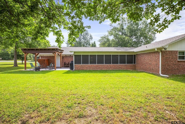 5513 Bostick Dr, Tyler, TX 75707 - rear view of property with a patio area, brick siding, a yard, and a sunroom