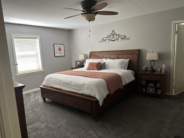 bedroom featuring a ceiling fan, dark colored carpet, and baseboards