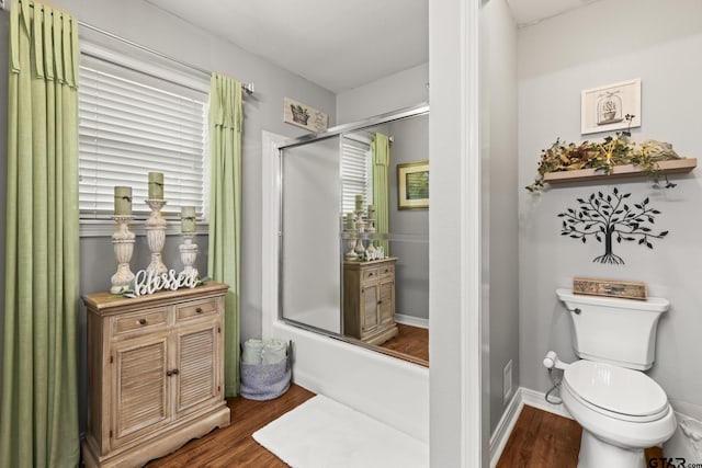 5513 Bostick Dr, Tyler, TX 75707 - full bathroom featuring wood finished floors, toilet, and shower / bath combination with glass door