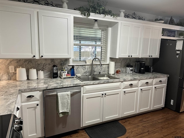 kitchen with stainless steel appliances, white cabinetry, a sink, and decorative backsplash