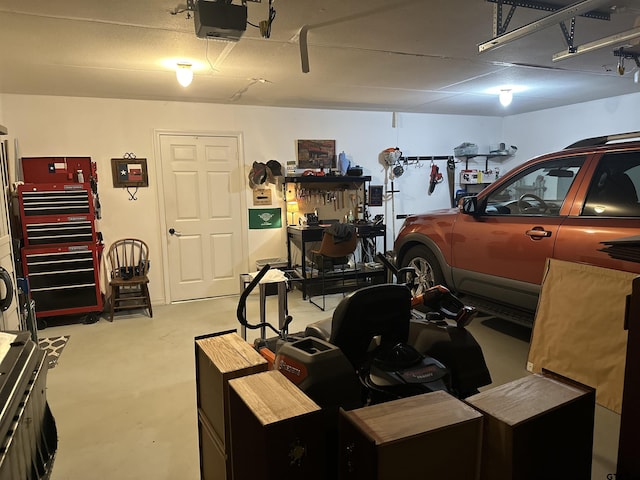 garage with a workshop area and a garage door opener