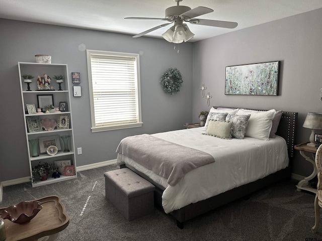 bedroom with baseboards, dark carpet, and a ceiling fan