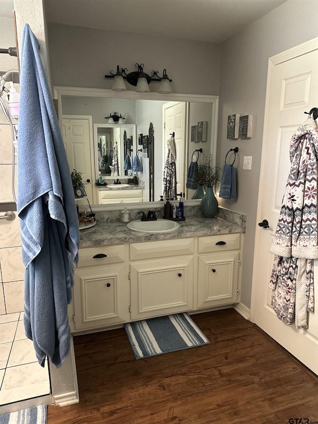 bathroom with wood finished floors and vanity