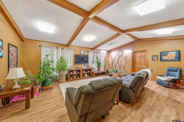 110 N Green St, Hawkins, TX 75765 - living room with lofted ceiling with beams, a textured ceiling, light wood-style flooring, and wood walls