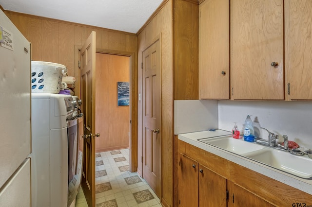 110 N Green St, Hawkins, TX 75765 - kitchen with wooden walls, light floors, washer / dryer, a sink, and light countertops