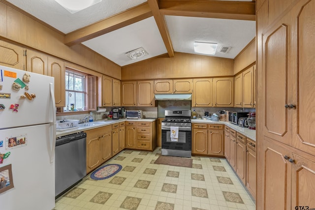 110 N Green St, Hawkins, TX 75765 - kitchen with under cabinet range hood, appliances with stainless steel finishes, vaulted ceiling with beams, and light countertops