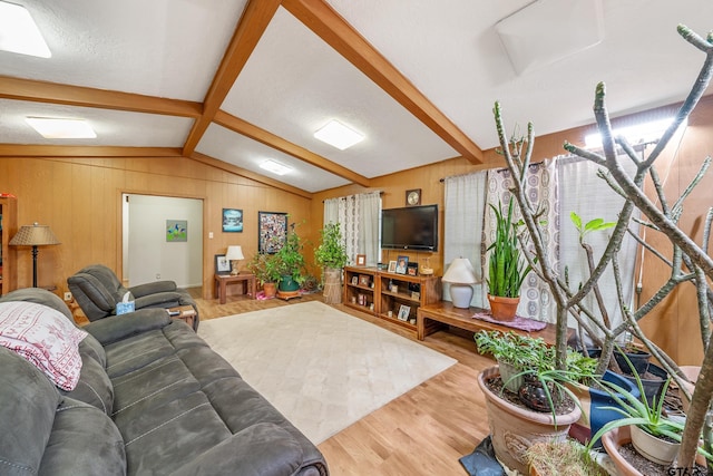 110 N Green St, Hawkins, TX 75765 - living area with lofted ceiling with beams, wood finished floors, and wood walls