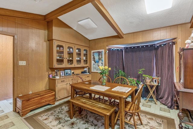 110 N Green St, Hawkins, TX 75765 - dining area with wooden walls, light floors, a textured ceiling, and lofted ceiling with beams
