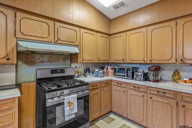 110 N Green St, Hawkins, TX 75765 - kitchen with under cabinet range hood, visible vents, appliances with stainless steel finishes, and light countertops