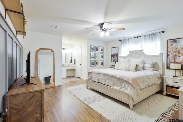 813 W Rieck Rd, Tyler, TX 75703 - bedroom featuring wood finished floors, connected bathroom, and a ceiling fan