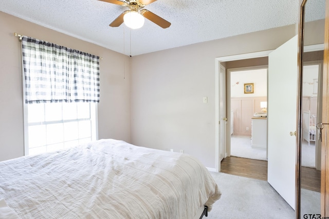 813 W Rieck Rd, Tyler, TX 75703 - carpeted bedroom featuring a textured ceiling and a ceiling fan