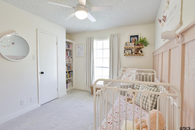 813 W Rieck Rd, Tyler, TX 75703 - carpeted bedroom featuring a textured ceiling, a crib, and ceiling fan