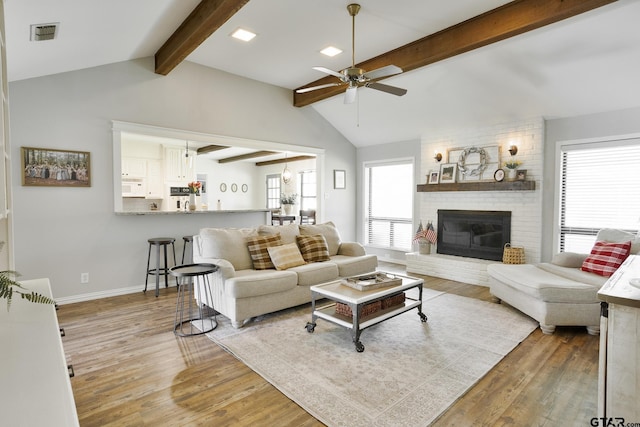 813 W Rieck Rd, Tyler, TX 75703 - living room with light wood-style floors, a ceiling fan, and a brick fireplace