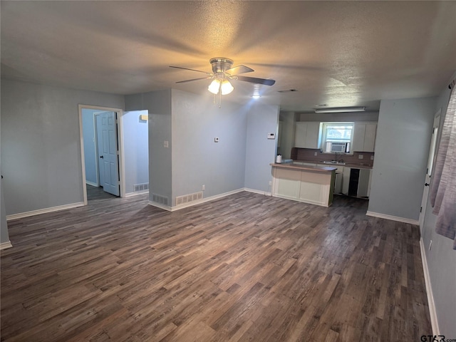 kitchen featuring dishwashing machine, dark wood-type flooring, ceiling fan, white cabinetry, and a textured ceiling