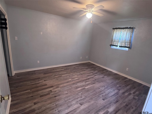 spare room featuring dark hardwood / wood-style floors and ceiling fan