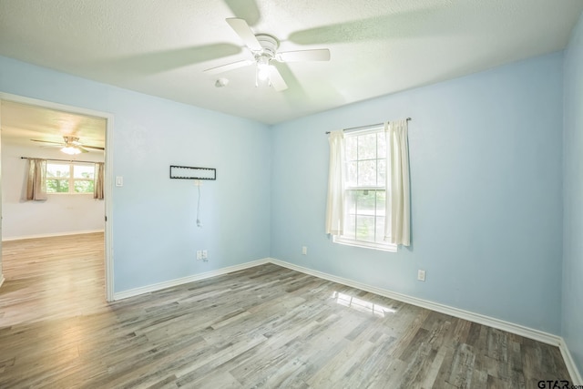 521 Hilltop Dr, Tool, TX 75143 - unfurnished room with ceiling fan, wood finished floors, baseboards, and a textured ceiling