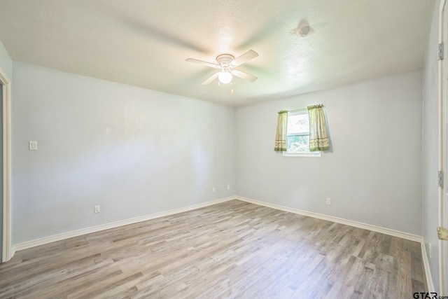 521 Hilltop Dr, Tool, TX 75143 - empty room featuring a ceiling fan, wood finished floors, baseboards, and a textured ceiling