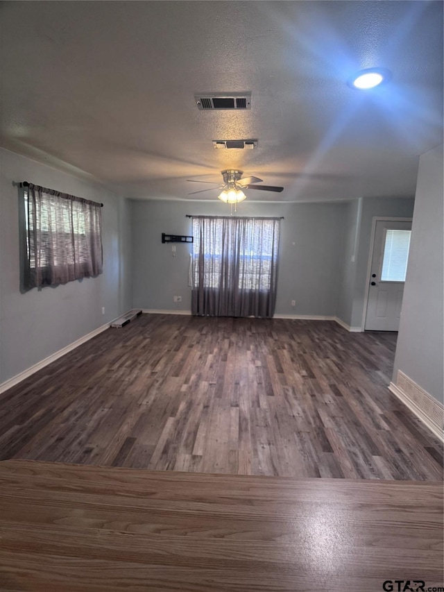 spare room featuring dark hardwood / wood-style floors, a textured ceiling, and ceiling fan