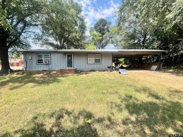 view of front of home with a carport and a front lawn