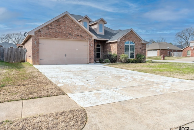 view of front of home featuring a front lawn and a garage