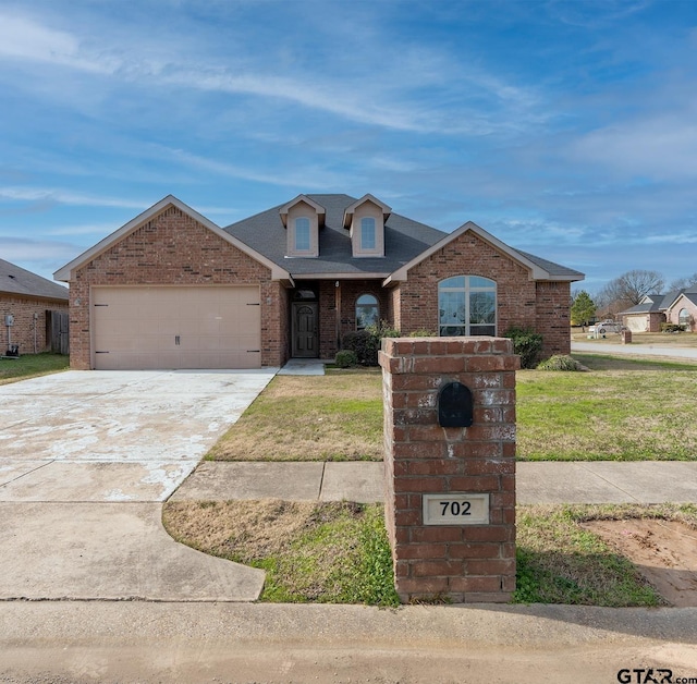 view of front of property with a garage and a front yard