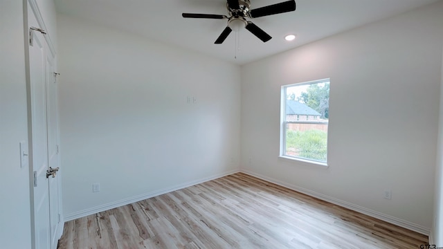 empty room featuring ceiling fan and light hardwood / wood-style floors