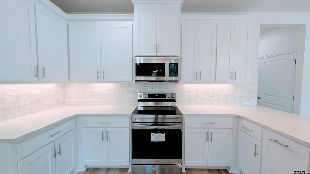 kitchen featuring white cabinetry and appliances with stainless steel finishes