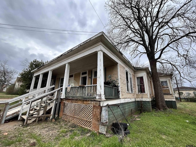 view of side of property with covered porch