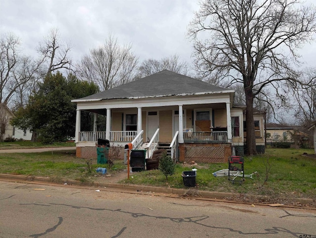 view of front of house with a porch and roof with shingles