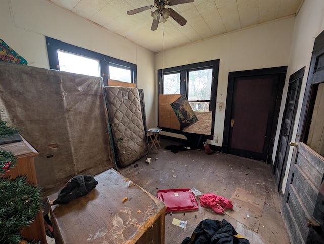 interior space with ceiling fan