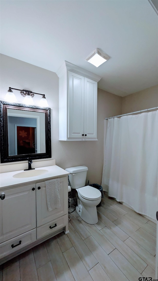 1300 N Broadway Ave, Tyler, TX 75702 - full bath with vanity, wood tiled floors, and a shower with curtain