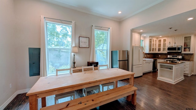 1300 N Broadway Ave, Tyler, TX 75702 - dining area featuring dark wood-type flooring, electric panel, crown molding, and recessed lighting