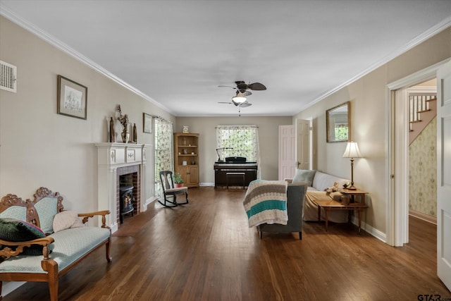 interior space with a ceiling fan, dark wood-type flooring, crown molding, baseboards, and a fireplace