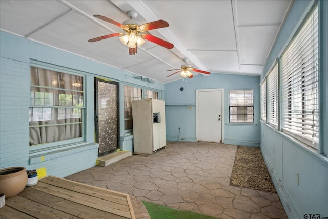 unfurnished sunroom featuring beamed ceiling and ceiling fan