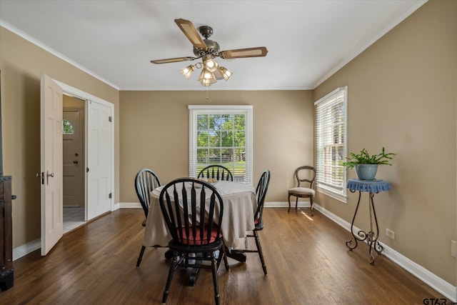 dining room with baseboards, ornamental molding, and dark wood-style floors