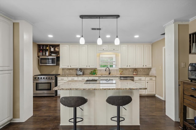 kitchen with stainless steel appliances, tasteful backsplash, visible vents, light stone countertops, and a breakfast bar