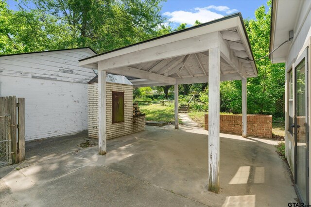 view of patio / terrace with a fire pit, a gate, and fence